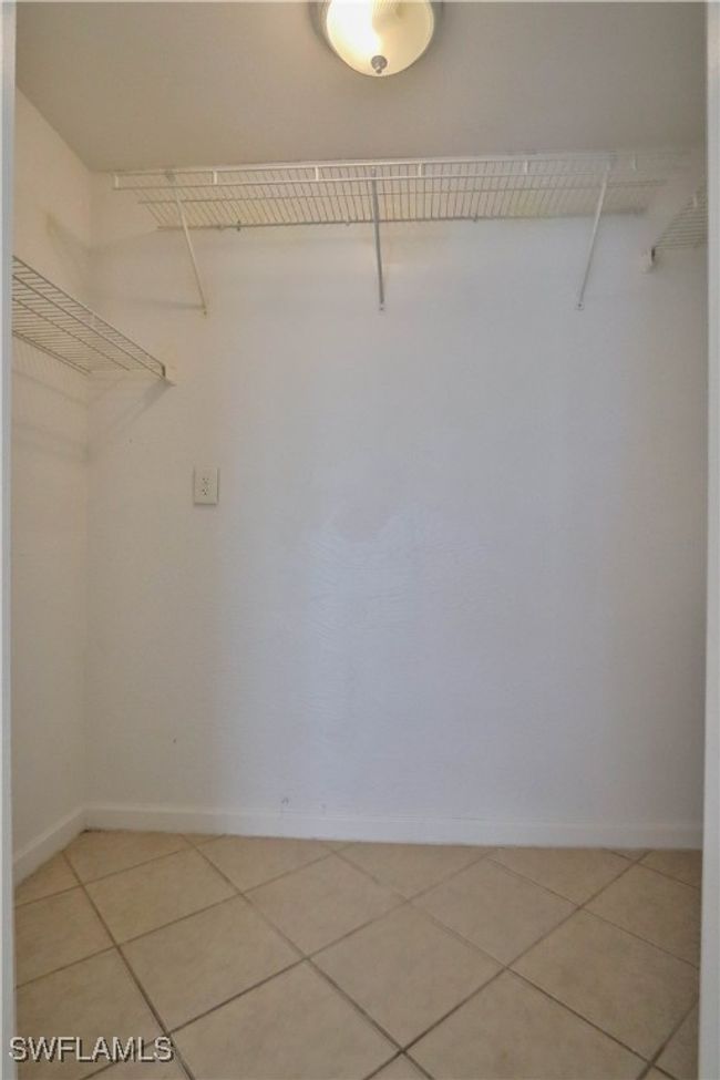 Walk in closet with light tile patterned floors | Image 6