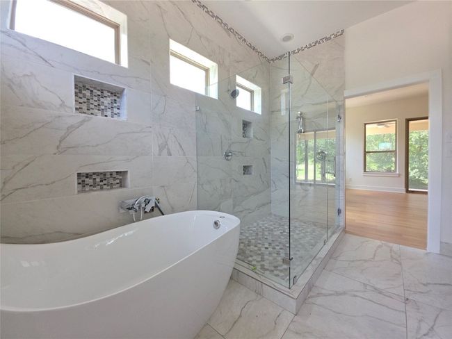 Bathroom with healthy amount of natural light, marble finish flooring, and a marble finish shower | Image 15