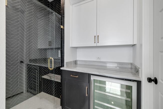 Indoor dry bar featuring beverage cooler | Image 25