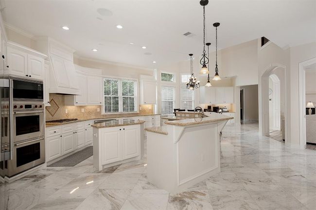 The light filled open concept kitchen/breakfast/family room offers so much storage space, and a walk-in pantry | Image 14