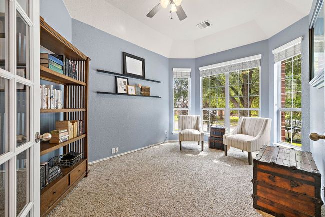 Living area featuring carpet floors, ceiling fan, healthy amount of natural light, and baseboards | Image 4