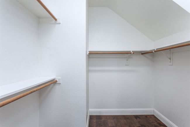 Spacious closet featuring dark wood-type flooring and vaulted ceiling | Image 20