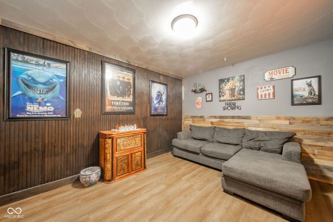 living room featuring wooden walls and wood finished floors | Image 21
