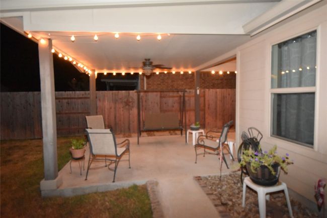 Back patio from sidewalk across back of home. | Image 33
