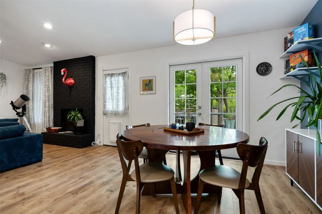 Dining room featuring light wood-style flooring, french doors, a fireplace, baseboards, and recessed lighting | Image 8