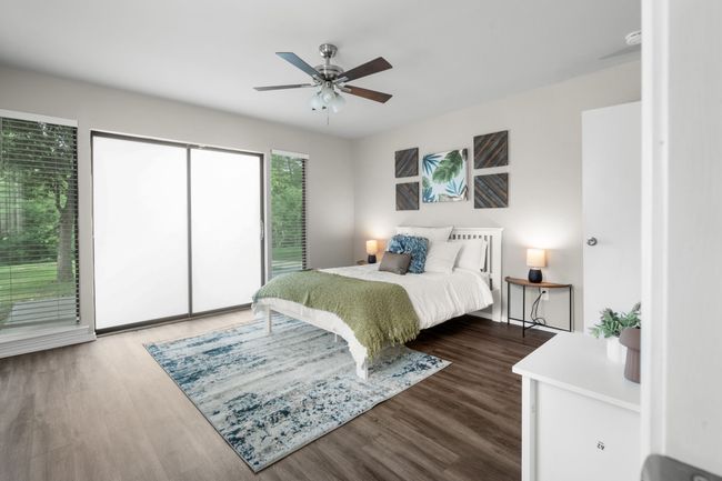 Bedroom featuring access to exterior, wood finished floors, and a ceiling fan | Image 15