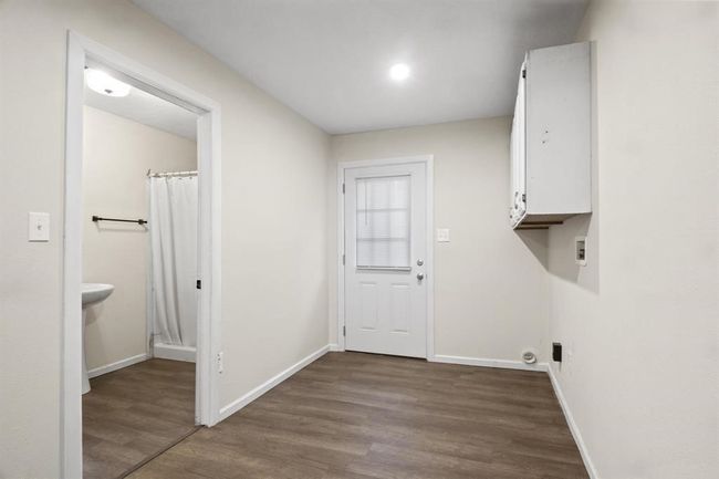Washroom with wood finished floors and hookup for a washing machine | Image 15