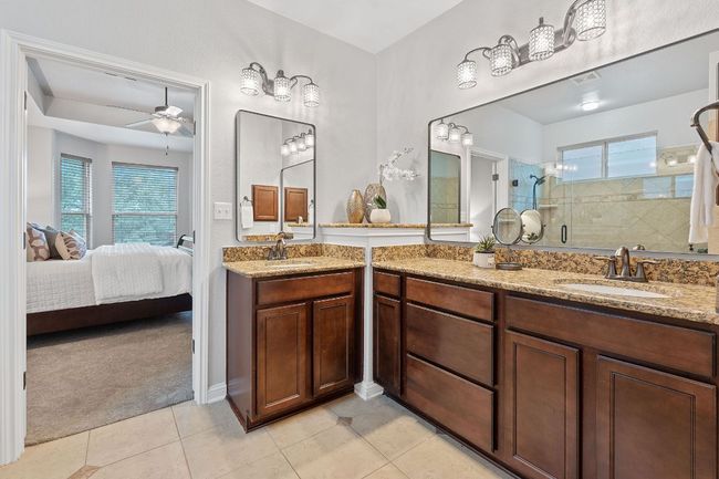 Ensuite bathroom with a walk-in shower and dual vanities. | Image 21