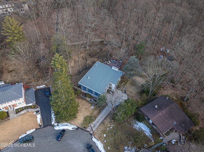 Tucked away on a private cul-de-sac in the coveted Pines Lake community, this sprawling 3, 640 sq. ft. contemporary home on 2.37 acres offers a unique blend of modern design, natural beauty, and timeless charm. | Image 52
