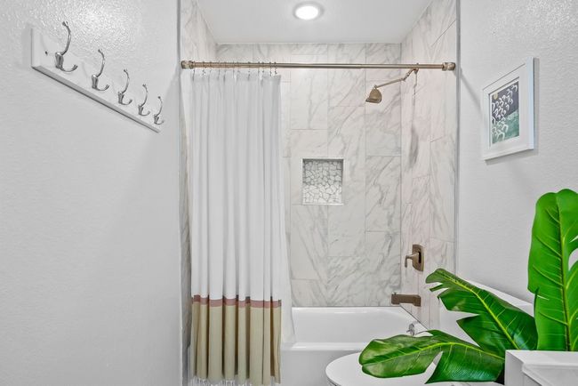 Spacious guest bath with tiled tub/shower combo | Image 26
