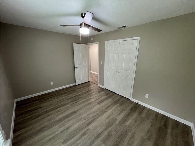 Unfurnished bedroom featuring wood finished floors and baseboards | Image 11
