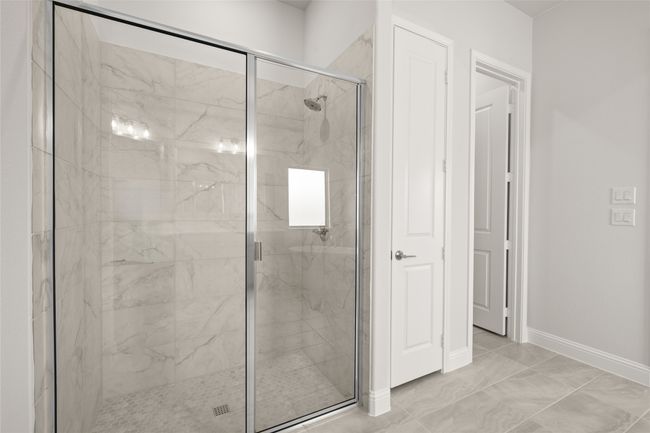 Full bathroom featuring a marble finish shower, baseboards, and marble finish floors | Image 19