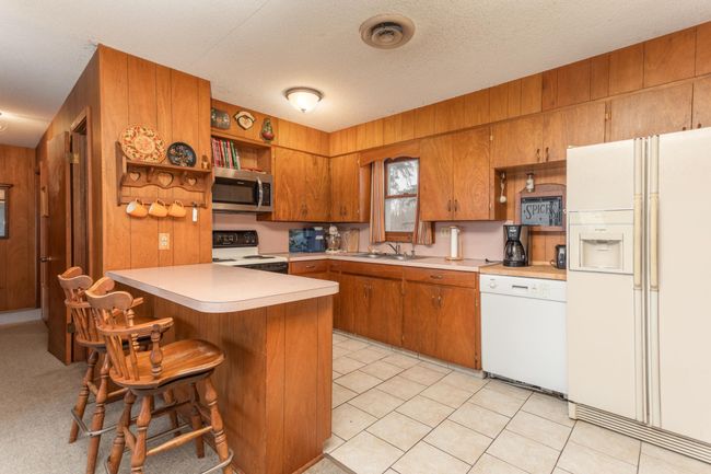 Kitchen is spacious with plenty of cabinets | Image 13