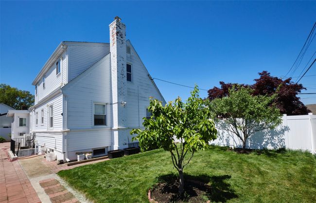 View of property exterior with a chimney | Image 28