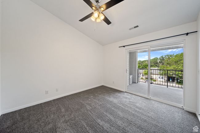 Empty room with vaulted ceiling, carpet, and ceiling fan | Image 16