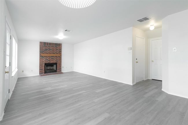 Powder room is across from door to garage. | Image 10
