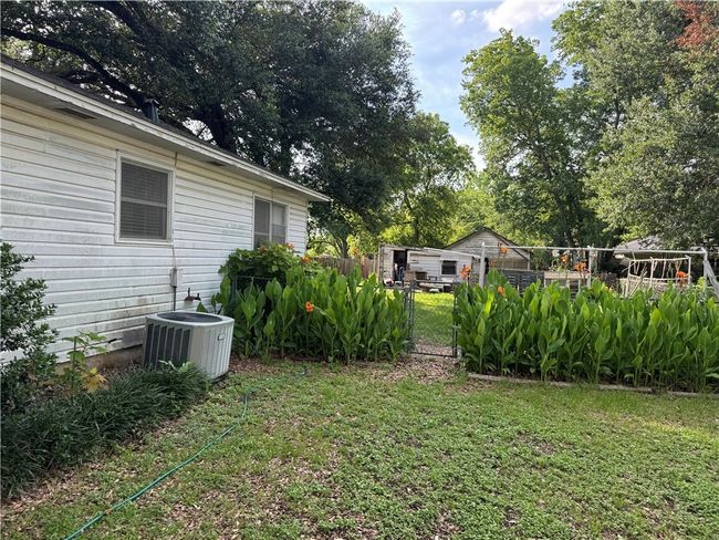 View of yard with central air condition unit and a gate | Image 17