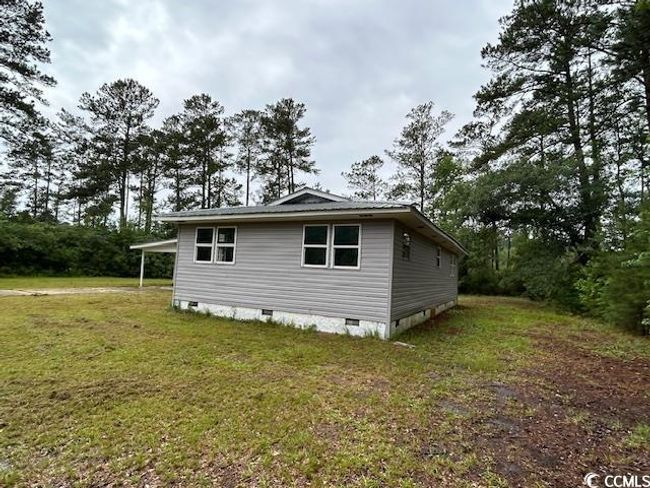 View of home's exterior featuring crawl space and a lawn | Image 6