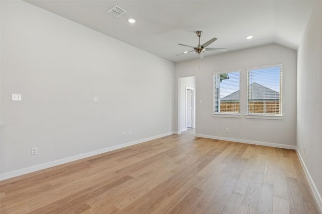 Spare room with ceiling fan, light wood-type flooring, recessed lighting, baseboards, and vaulted ceiling | Image 6
