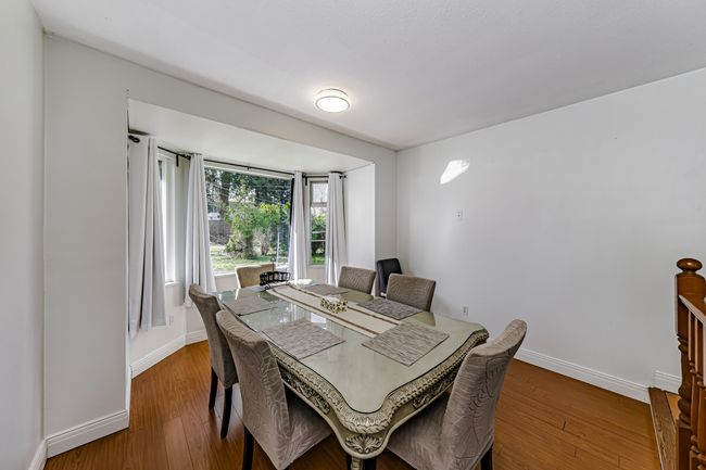 Dining space with baseboards and wood finished floors | Image 6