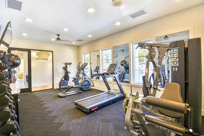 Gym featuring ceiling fan and carpet | Image 31