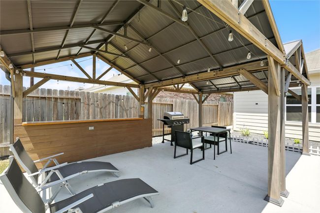Gorgeous covered patio with stand up bar for entertaining. | Image 24