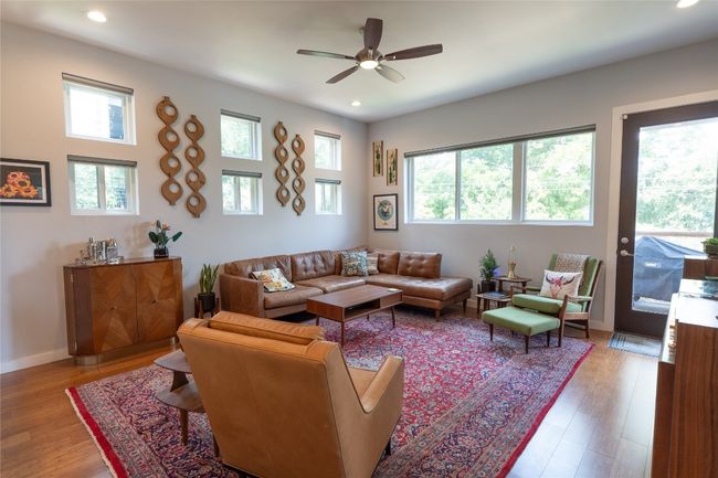 Living area with plenty of natural light, ceiling fan, recessed lighting, and wood finished floors | Image 31