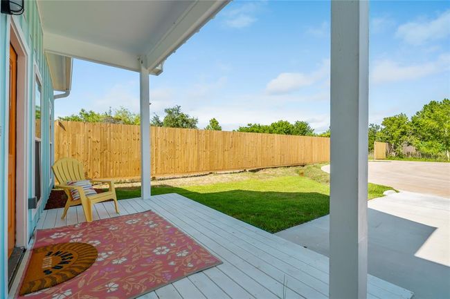 Charming front porch with cozy seating, perfect for relaxing and enjoying the outdoors. | Image 20
