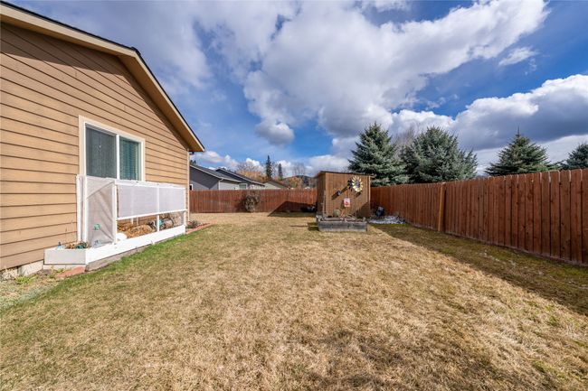 View of yard featuring an outbuilding, a vegetable garden, and a fenced backyard | Image 21