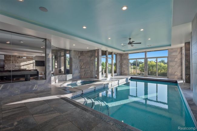 Indoor pool featuring ceiling fan | Image 29