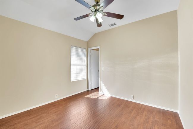 bedroom 3 with lofted ceiling, hardwood / wood-style floors, and ceiling fan | Image 19