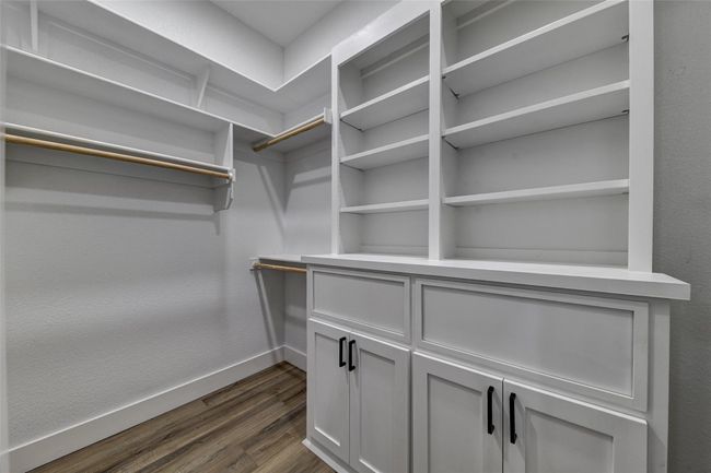 Walk in closet with dark hardwood / wood-style floors | Image 13