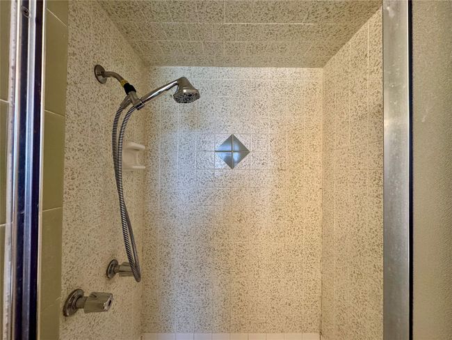 Room details featuring tiled shower | Image 26