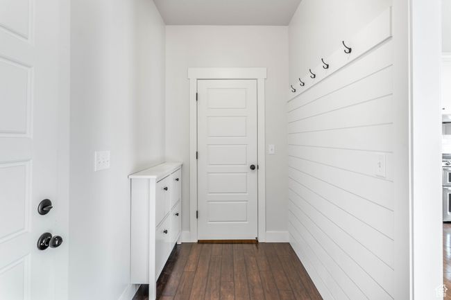 Mudroom with garage door to the left and coat closet straight ahead. | Image 22