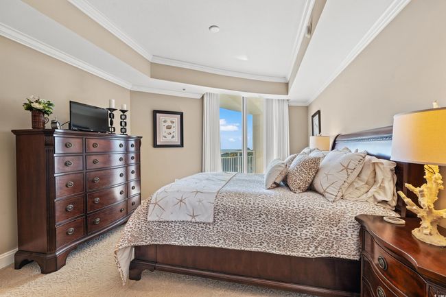 Bedroom with crown molding, a tray ceiling, and carpet floors | Image 22