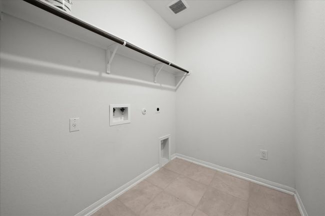 Laundry room featuring hookup for a gas dryer, hookup for an electric dryer, hookup for a washing machine, and baseboards | Image 31