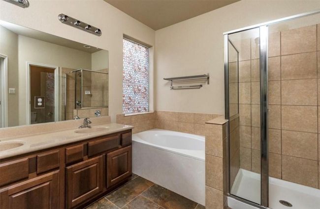 Full bath with a stall shower, a bath, double vanity, and toilet | Image 15
