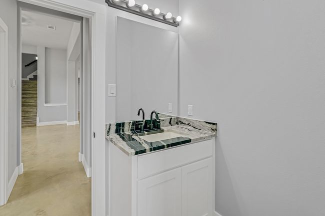 Bathroom with concrete floors, baseboards, and vanity | Image 17
