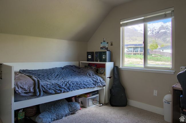 Bedroom with vaulted ceiling, baseboards, and carpet floors | Image 21