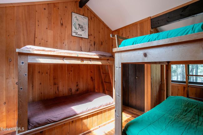 bedroom 2 with two sets of built-in bunk beds and slider to small deck | Image 8