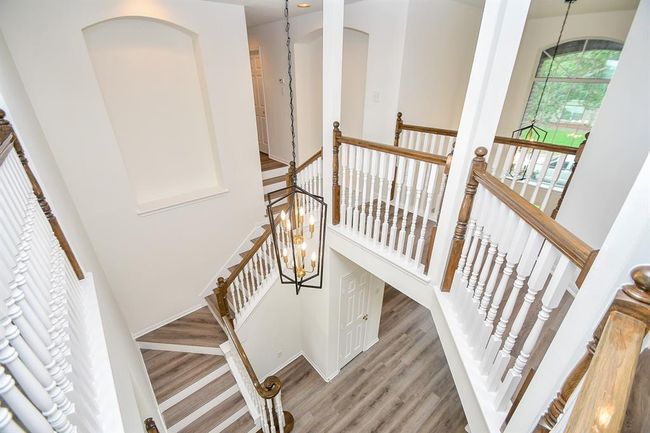 Let's head on upstairs to check out your FOUR spacious bedrooms! This beautifully crafted staircase leads you to a light-filled landing and straight to your game room! | Image 22