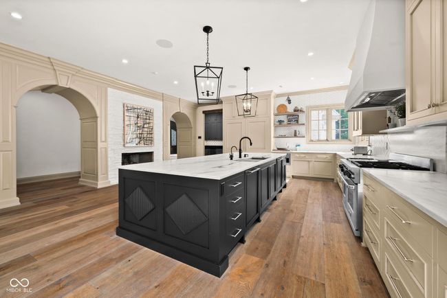 kitchen featuring custom range hood, high end stainless steel range | Image 13