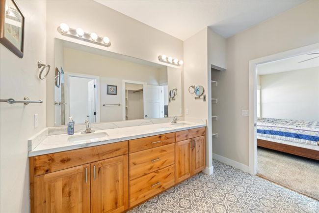 Full bath with baseboards, a sink, double vanity, and ensuite bathroom | Image 26