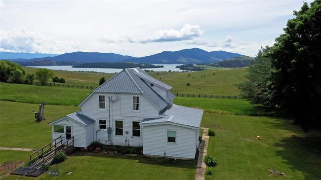 Rear view of house with a yard and a water and mountain view | Image 23