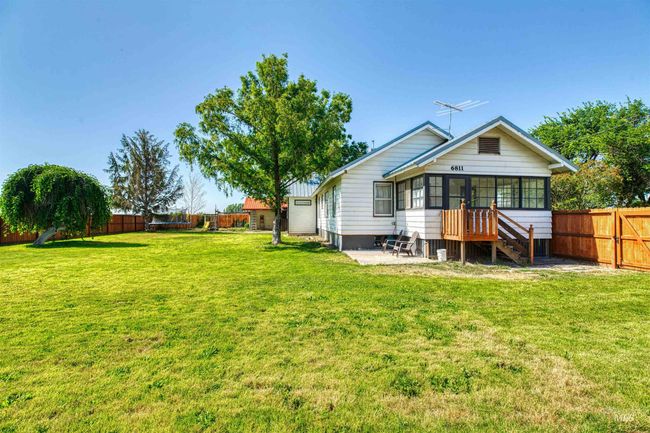 Back of house featuring a sunroom, a fenced backyard, and a patio | Image 32