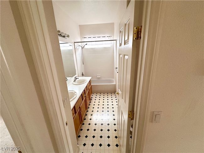 Bathroom with tile patterned floors, double vanity, and tub / shower combination | Image 14