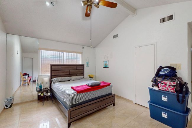 Bedroom featuring high vaulted ceiling, beamed ceiling, ceiling fan, and visible vents | Image 18