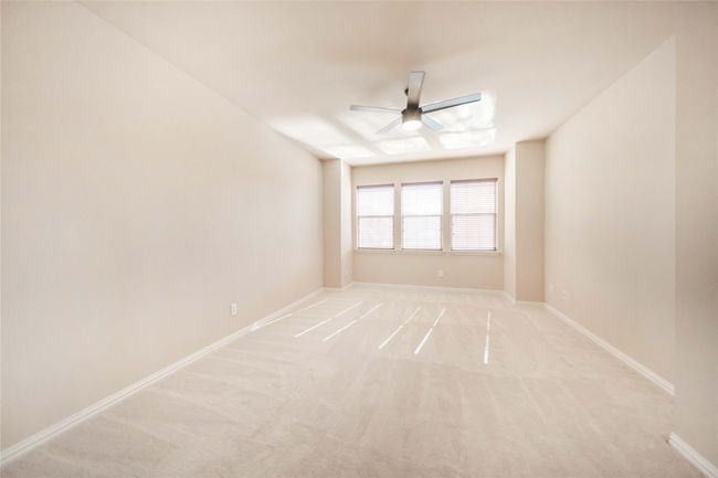 Spare room with ceiling fan and light colored carpet | Image 35