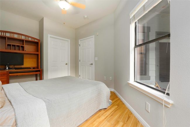 Bedroom with light wood-type flooring and ceiling fan | Image 21