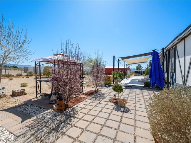 View of patio with a pergola and fence | Image 49